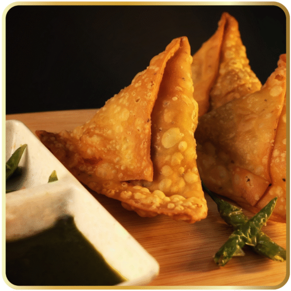 Golden crispy samosa filled with spiced potato from Gangdhar Mithaiwale