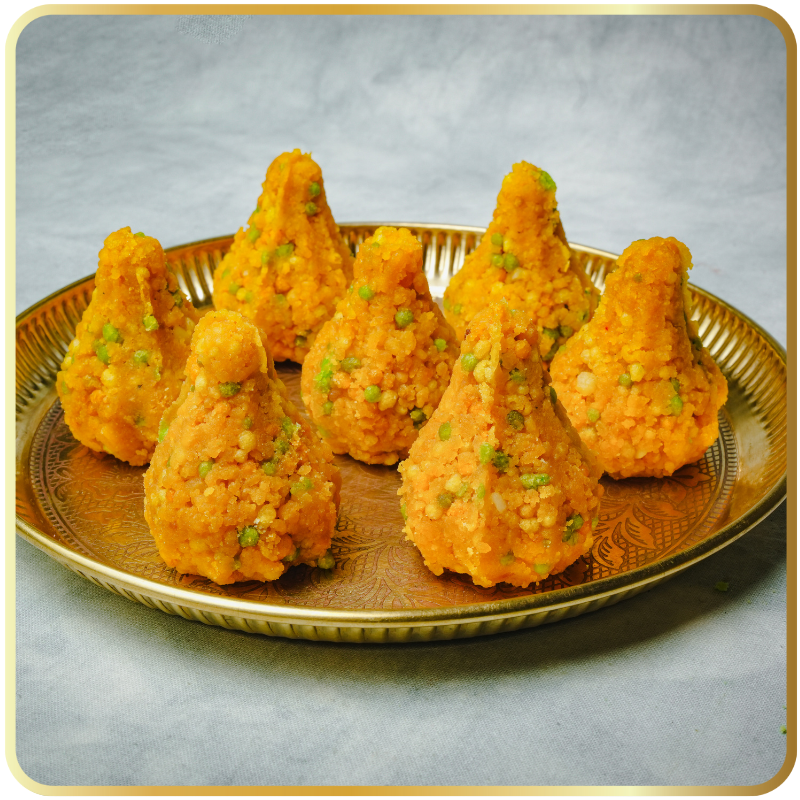 Motichoor Modak single piece – saffron-colored soft modak made with boondi by Gangdhar Mithaiwale – naivedya sweet